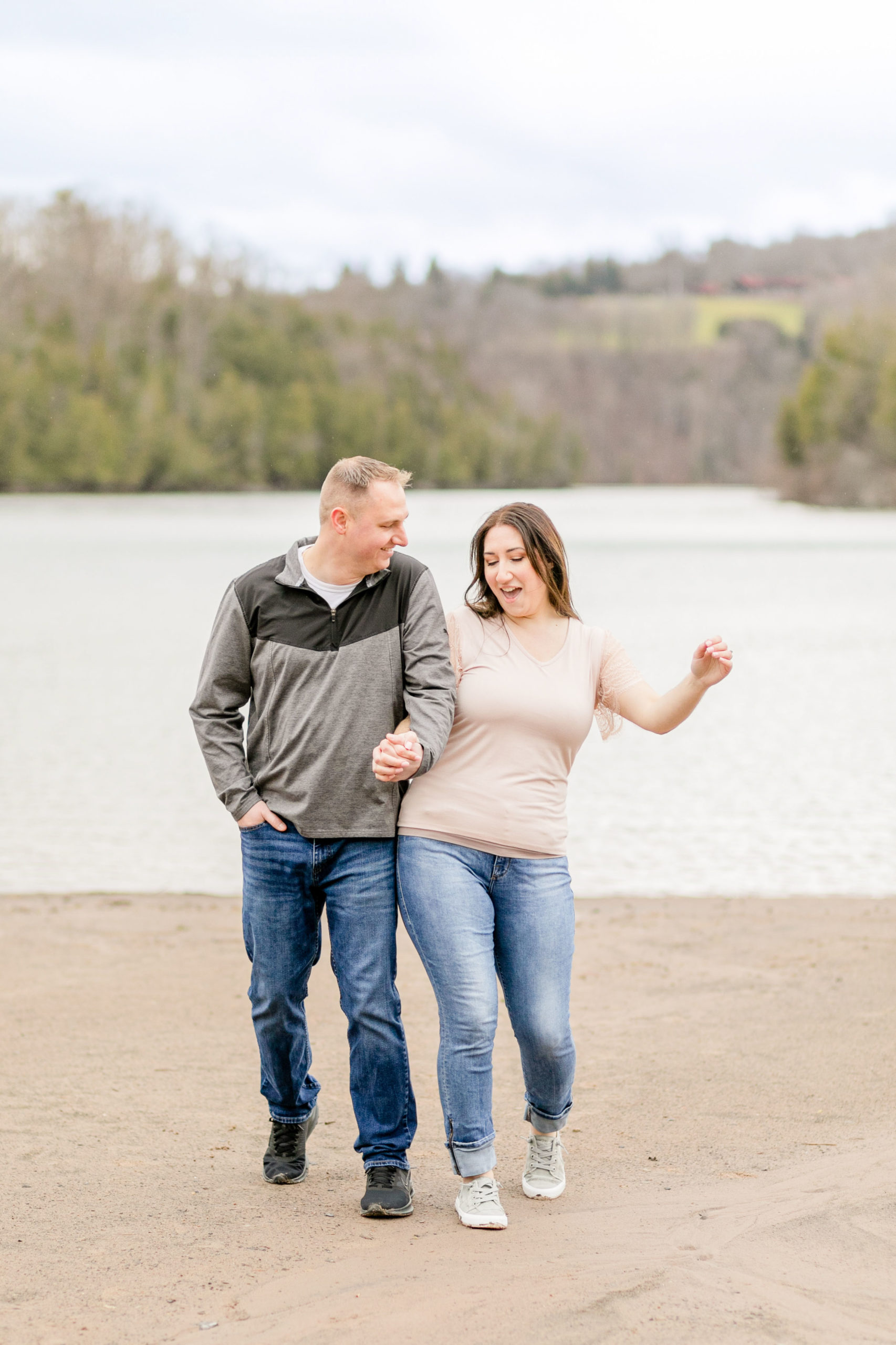 Couple walking next to each other at Green Lakes while having fun at their engagement session
