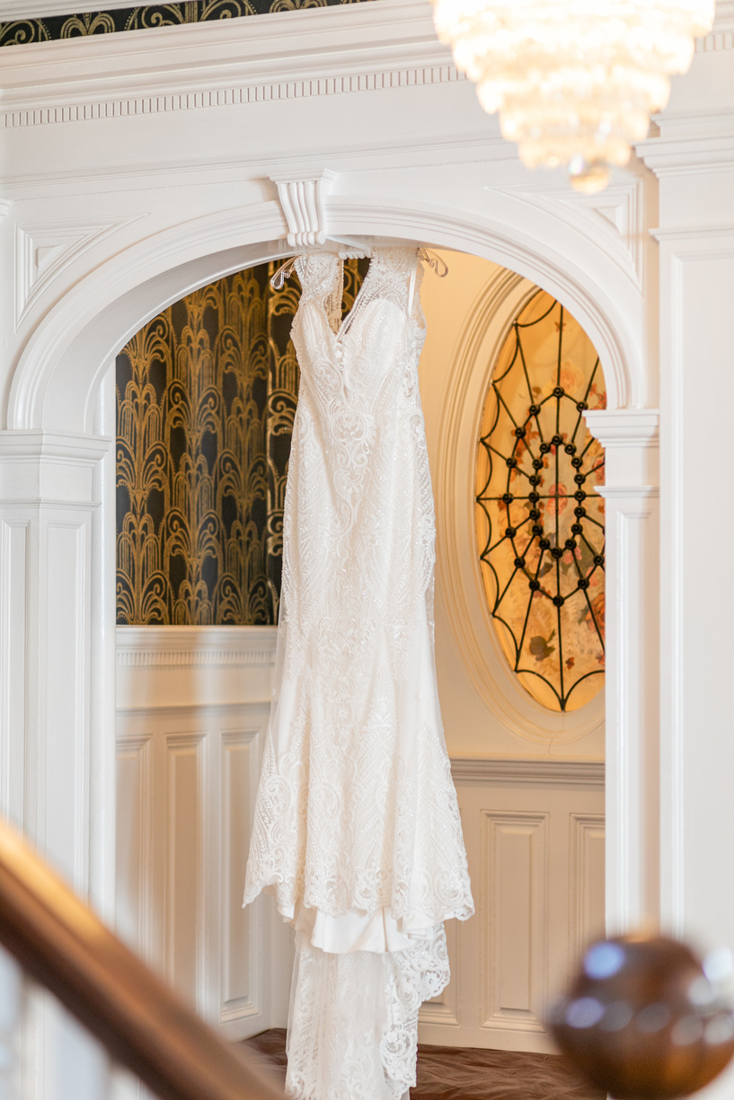 wedding gown hanging in the doorway