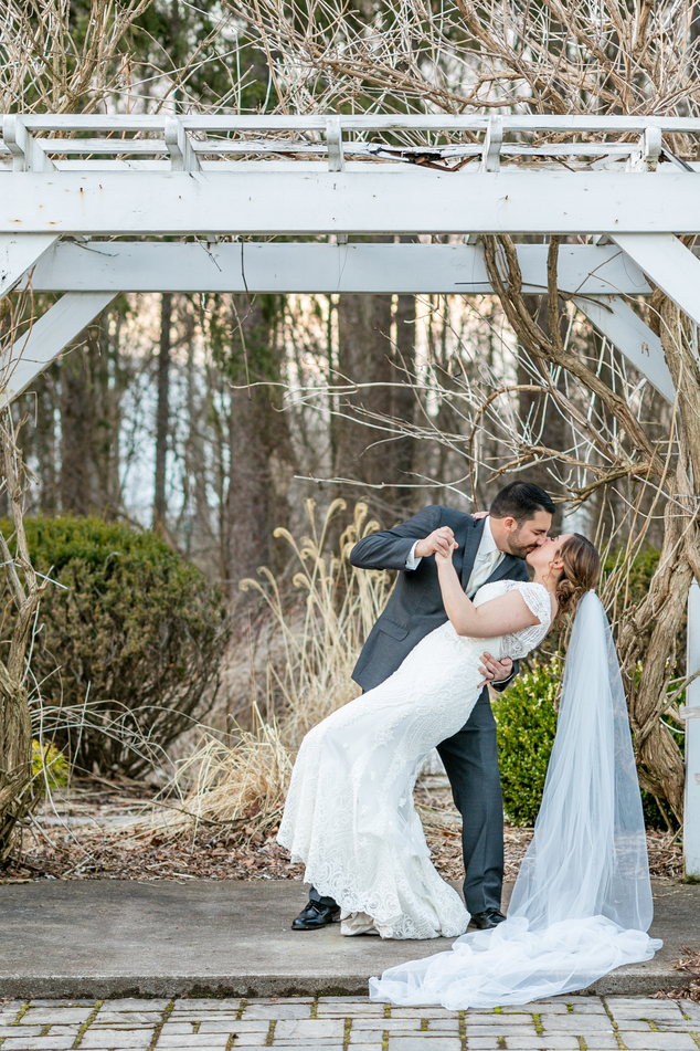 groom dipping bride and kissing taken by an Upstate NY Wedding Photographer
