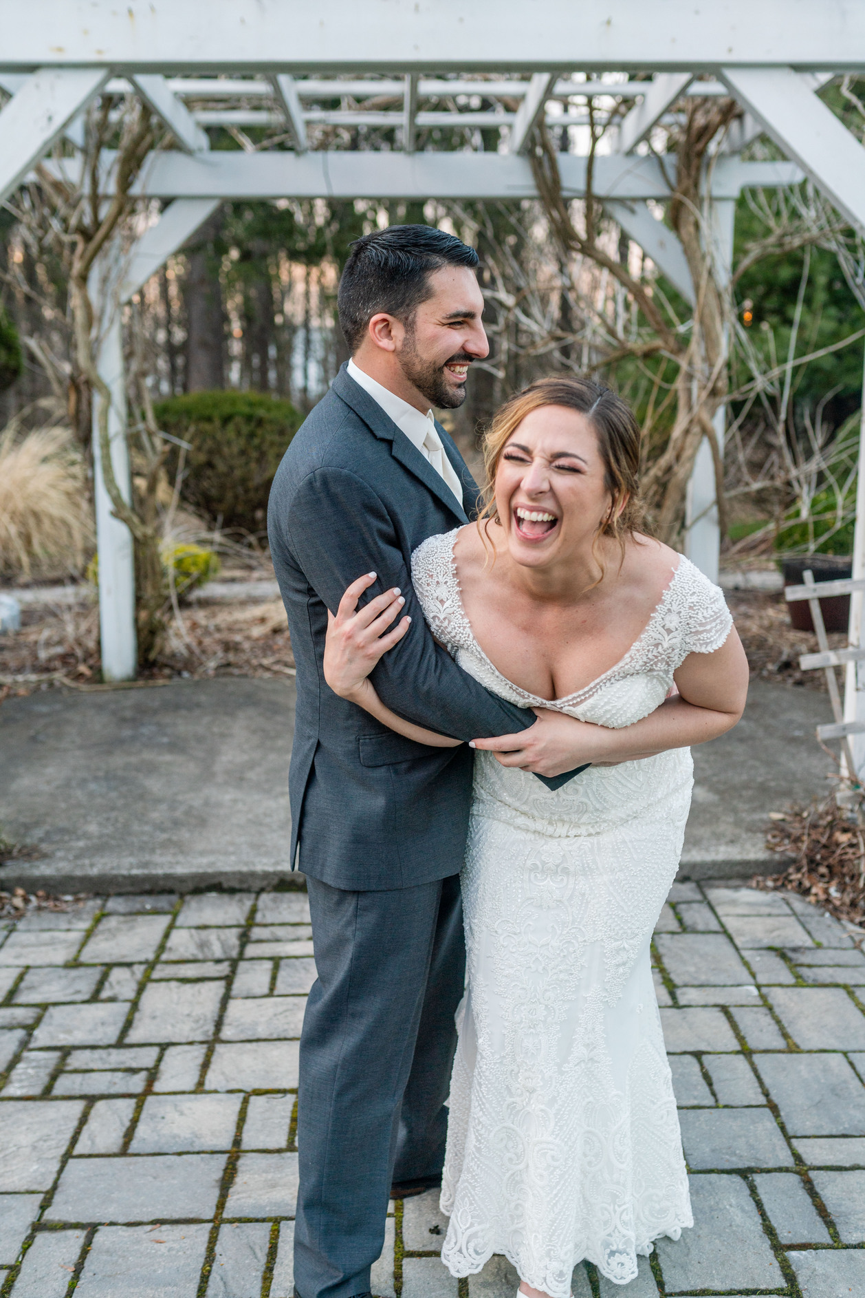 Bride and groom laughing looking at the camera taken by a Upstate NY Wedding Photographer