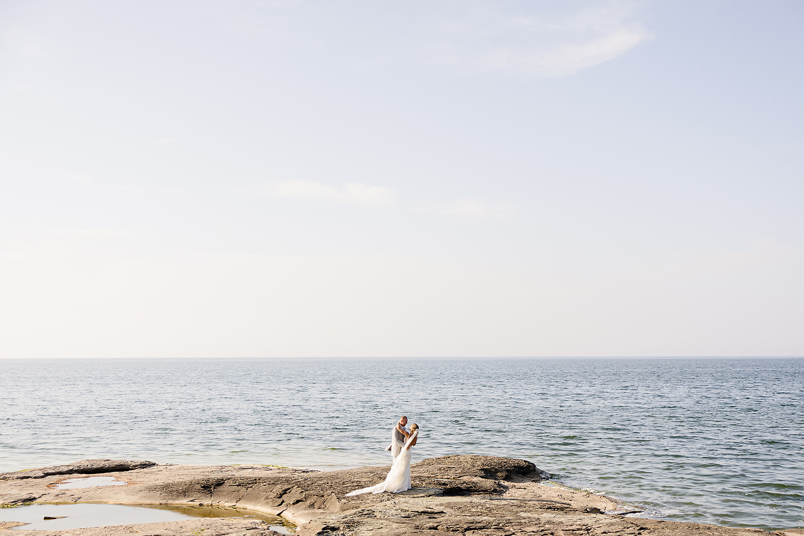 Bride and groom overlooking lake ontario and bayshore grove
